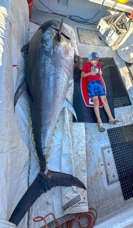 Gunner Stackpole, son of captain Jared Stackpole, poses next to a 736-pound tuna. The fish won Stackpole second place in the tournament. Courtesy of Boothbay Harbor Tuna Challenge