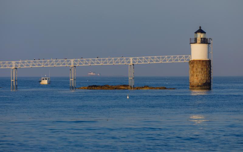 As seen last year - A now historic view, as a result of the January storms, of the Cuckolds light station in the distance along with a lobster boat nicely framed up by the support stanchions under the catwalk. Mike Leonard photo