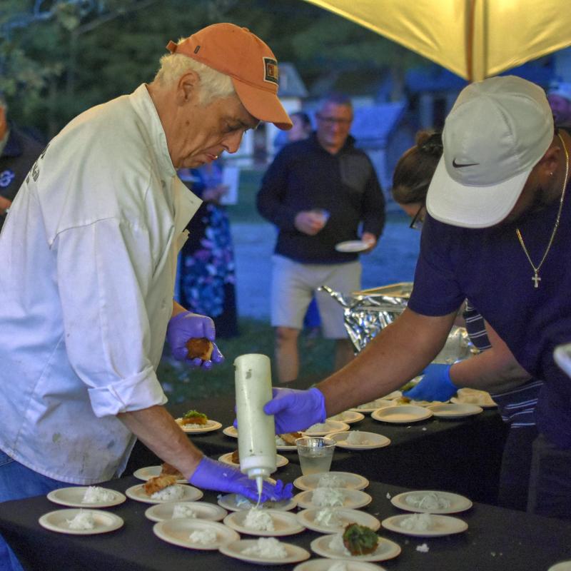 Mine Oyster owner Ralph Smith, left, helps prepare food. FRITZ FREUDENBERGER/Boothbay Register