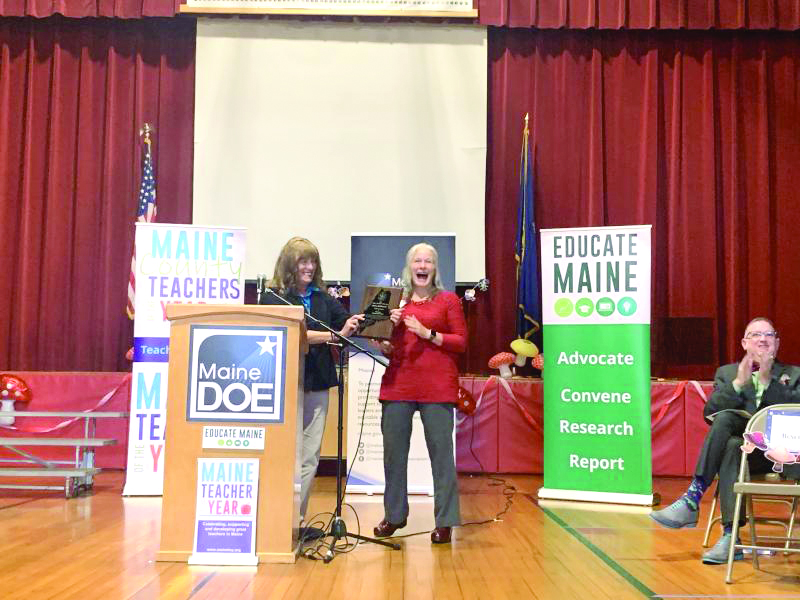 Maine Education Commissioner Pender Makin hands Hallowell the award for Maine Teacher of the Year. SUSAN JOHNS/Wiscasset Newspaper