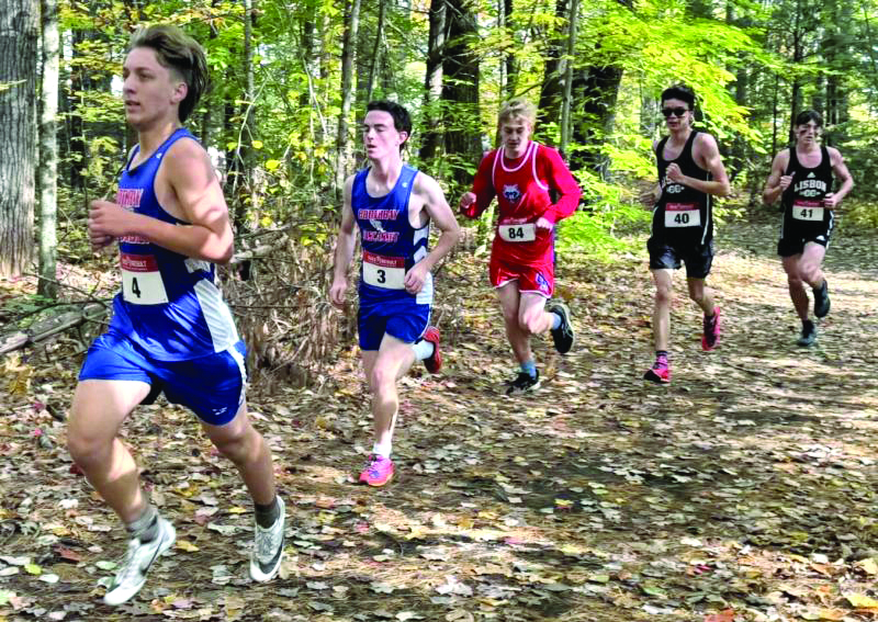 A BOYS PACK RUNS through the woods at the MVC championships Oct. 19. Courtesy of Josiah Winchenbach Boy runners