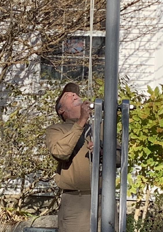 Vietnam veteran Tim Hanley lowers the U.S flag Nov. 11 to begin Southport Memorial Libary's Veterans Day ceremony. BILL PEARSON/Boothbay Register Tim