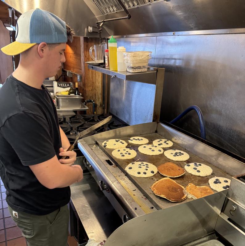 Griffin Yereance waits for some pancakes to cook. Jen Mitchell photo Griffin Yereance