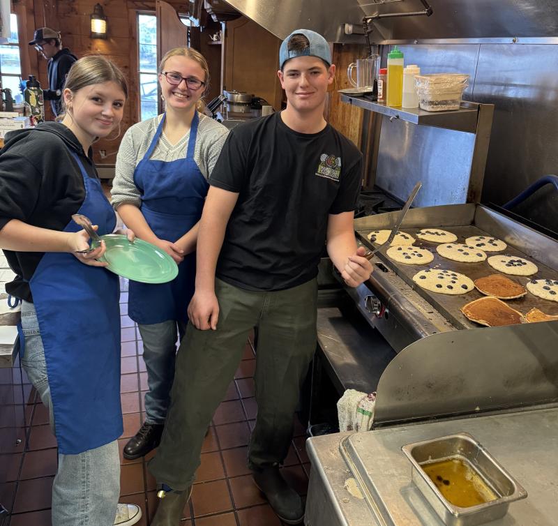 Manning the griddle and more are, from left, Aileigh Johnson, Hannah Kreft and Griffin Yereance. Jen Mitchell photo Cooks