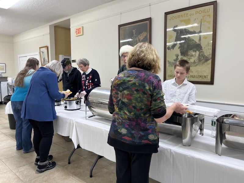 Getting dinner served. Courtesy of Barb House Christmas dinner at Legion Hall