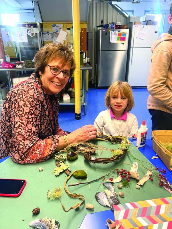 SCS Principal Lisa Clarke works on a wreath with a student. Courtesy of Eileen Higgins Mrs. Clarke