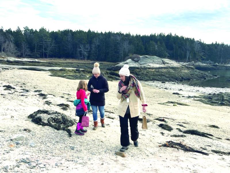 SCS teacher Julie Browne and students comb the beach for wreath items. Courtesy of Eileen Higgins Julie Browne