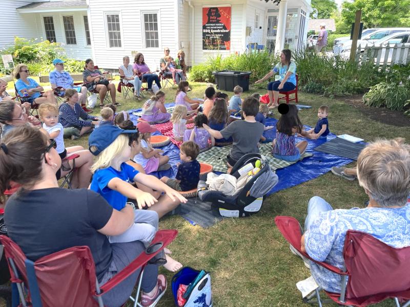 Children's Coordinator Jen Betts leads a summer storytime on BHML's lawn. Courtesy of Boothbay Harbor Memorial Library. Children's Coordinator Jen Betts leads a summer storytime on BHML's lawn. Courtesy of Boothbay Harbor Memorial Library.