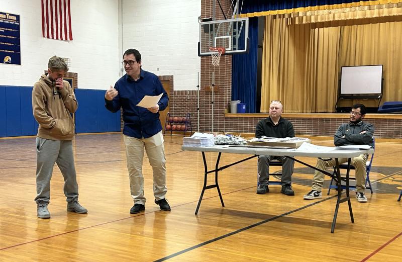 Junior varsity coach Ed Crocker talks about Jayden Orne during his presentations at the awards ceremony. Seated are assistant coaches Kevin Ames, left, and Julian Aponte. KEVIN BURNHAM/Boothbay Register Coach Crocker