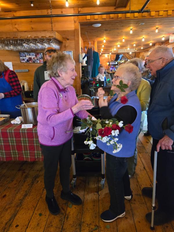 Dee and Howard Wright present roses to Community Lunch volunteer Nancy Van Dyke. Darrell Gudroe photo Dee and Howard Wright present roses to Community Lunch volunteer Nancy Van Dyke. Darrell Gudroe photo