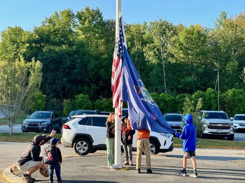 A father points out to his Pre-Ker how valuable the “big kids” are in the everyday functioning of Edgecomb Eddy School. Raising the flag are Maxine, daughter of Pascale and Kirk Zehm; Bryson, son of Melissa and Joseph Hersom; Mason, son of Nicole McKay and Patrick Wenners; and Sam, son of Daniel and Maureen Cooper. Students are residents of Alna and Edgecomb. Courtesy photo A father points out to his Pre-Ker how valuable the “big kids” are in the everyday functioning of Edgecomb Eddy School. Raising the flag are Maxine, daughter of Pascale and Kirk Zehm; Bryson, son of Melissa and Joseph Hersom; Mason, son of Nicole McKay and Patrick Wenners; and Sam, son of Daniel and Maureen Cooper. Students are residents of Alna and Edgecomb. Courtesy photo