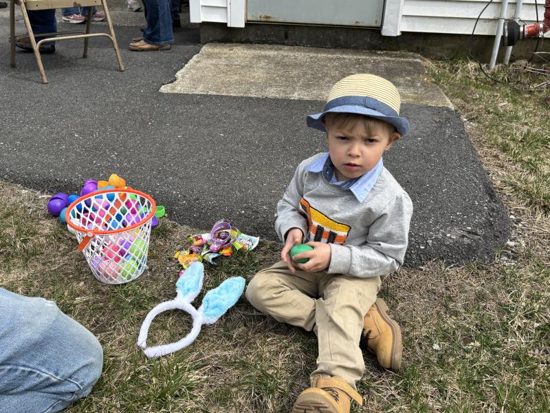 Zion Lewis checks out his egg hunt treasures. LISA KRISTOFF/Boothbay Register LISA KRISTOFF/Boothbay Register