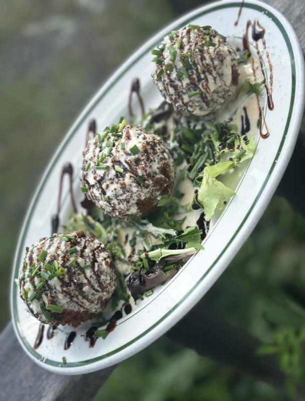 Lobster Arancini: Three lobster-stuffed risotto balls panko fried, with a lobster cream sauce and drizzled with a blueberry balsamic then dusted with Cojita cheese! A fan favorite at the Claw Down. Courtesy of Brady’s Seafood
