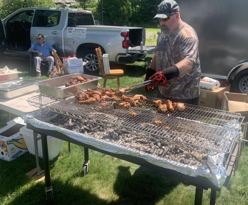 Ed Harmon Jr. is kept busy barbecuing chicken during the Aug. 2 Boothbay V.E.T.S. fundraiser. BILL PEARSON/Boothbay Register EHJ