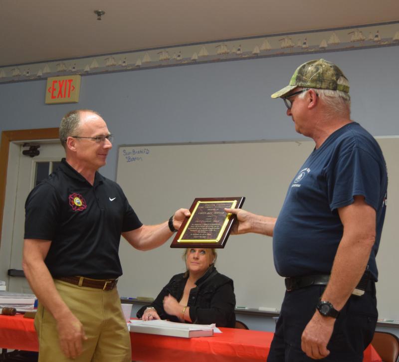 Edgecomb Fire Chief Roy Potter, right, accepts the Past Presidents Award from Waldoboro Fire Chief Paul Smeltzer on Wednesday, Aug. 20. The award commemorated Potter's time as president of the Lincoln County Fire Chiefs Association. Christina Wallace photo Potter