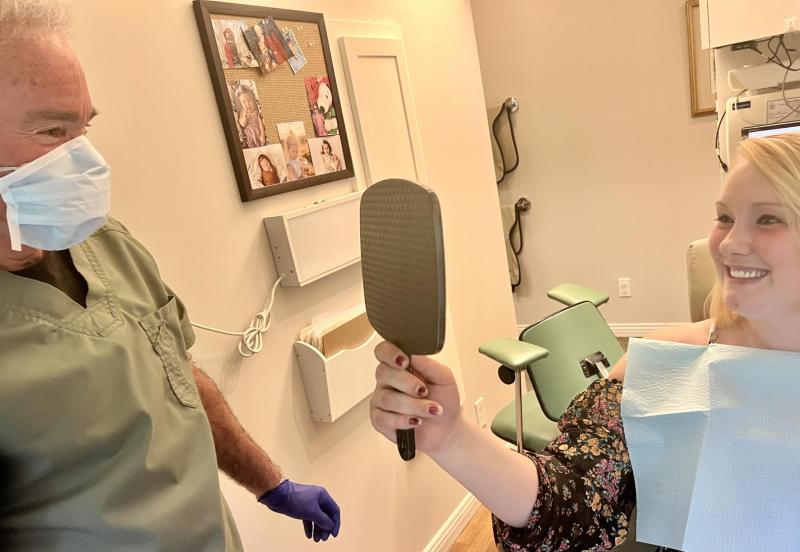 Dr. David Pier with Sam, one of the 17 women domestic abuse survivors whose smiles he has restored through the Finding Our Smiles program of pro-bono dental care. Photo by Patrisha McLean
