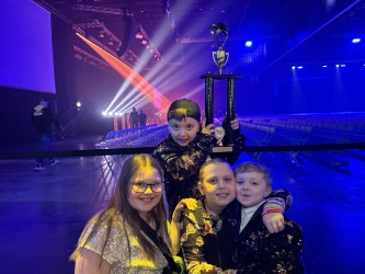  Evelyn Michaud, Lily Billings, Louie Mirabile and Oscar Mirabile pose for a photo with the team trophy while waiting for the theater to open. Emily Mirabile photo