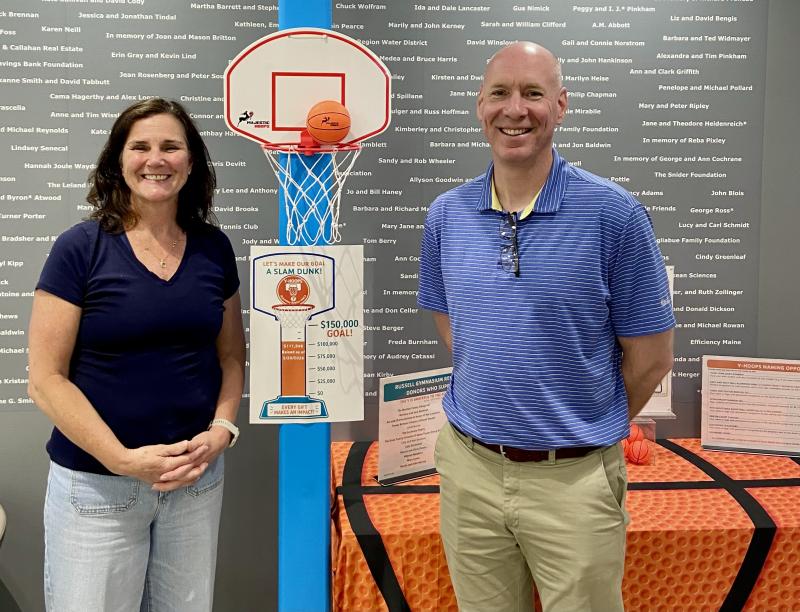 Lesley and Brian Blethen stand next to the fundraising thermometer. They are helping to raise money for new bleachers in the Boothbay Region YMCA gym. Courtesy photo