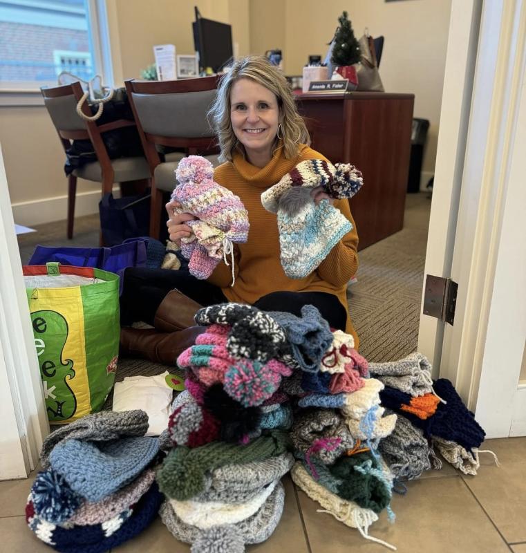 Vice President and Community Engagement Officer Michelle Curtis with hats and mittens. Courtesy photo