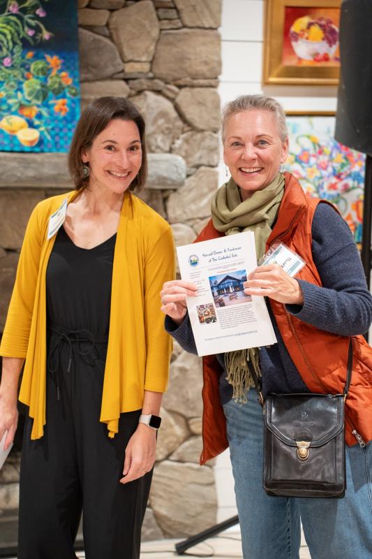 Wiscasset's Fiction Bookshop owner Toni Chappell collects a raffle prize of an evening dinner event at Contented Sole donated by Veggies to Tables. Melissa Keyser photo