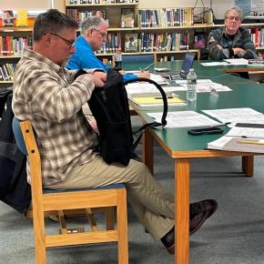 CSD trustee Matt Doucette examines a shielded backpack during the board's Feb. 12 meeting. FRITZ FREUDENBERGER/Boothbay Register