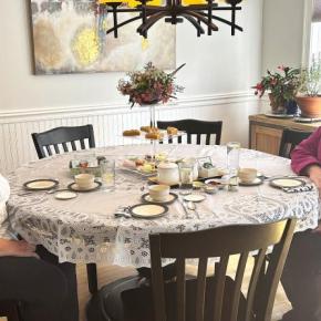 BRGC members Karen Iliades, left, and Cathy Fisher seated at Karen's table set with samplings of fare typically served at Afternoon Tea. LISA KRISTOFF/Boothbay Register