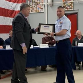 Mike Tomko presents a representative of U.S Coast Guard Boothbay Harbor with the Spirit of America Tribute. ISABELLE CURTIS/Boothbay Register