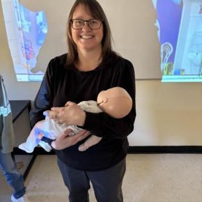 Jennifer Harris, of First Point Training, holds a training infant used in the American Red Cross Babysitter Training. Courtesy of Raye Leonard