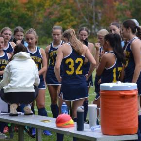 Coach Jax Hepburn talks with her players before the start of a recent game. KEVIN BURNHAM/Boothbay Register