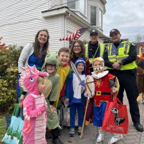 A group stops for a photo with Boothbay Harbor police officers near Grover's Hardware during the 2025 parade. Bethany Schmidt photo