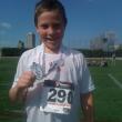 Adam is all smiles after receiving his medal.