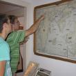 Lupieka, foreground, and Joshua Edwards look at a historic map of the Boothbay region at the Balmy Days Museum.