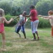Tyrese, 10, from the Bronx, N.Y., second from left, and Reanna, 12, from Brooklyn, N.Y., third from left, have fun with a water hose during their visit with the Eve and Robert Conlin family in Boothbay.