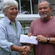 John Webster, proprietor of Orne’s Candy Store, gives $400 to Betsy Wing, treasurer of the Boothbay Region Food Pantry. 