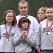 Special Olympians Grace Giles, Valerie Giles, and Vincent Giles front row, stand with Dylan Geyer and long-time teacher and mentor Toby LeConte during Sunday's golf tournament. 