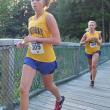 Hannah Morley and Morgan Crocker cross the bridge at Penny Lake. Morley and Crocker finished second and fifth place respectively at the first home meet of the season. RYAN LEIGHTON/Boothbay Register