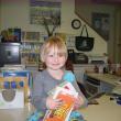 Audrey gathers some carefully selected books to read until she returns for Story Time next week.