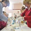 Jane Lunt, left, and Penny Thumith work together to construct cocoa cones