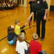 Ellie Logan shows students one of her two Olympic gold medals. KEVIN BURNHAM/Boothbay Register