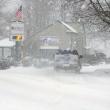 A snowplow turns on to Oak Street in Boothbay Harbor near The First bank at 9 a.m. Friday morning as snow starts to pile up. GARY DOW/Boothbay Register