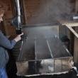 Finch checks boiling sap March 25 at Hidden Treasure Farm in Jefferson. BEN BULKELEY/Boothbay Register