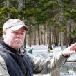 Mike Warren points out spots on the ice off the Penny Lake Bridge where his new 8-week old puppy chased wood ducks last week. KATRINA CLARK/Boothbay Register
