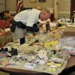 Officer Mercier searches through some of the goods recovered from the Fuller residence at Boothbay Harbor Town Office March 28. Police have thousands of items to sort through and compare to individual itemized lists from area burglaries. SUE MELLO/Boothbay Register