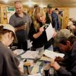Sophia Stark, with membership papers in hand, waits to be officially signed in as a member by Treasurer Keith Royal. Stark was one of ten new members who joined the association during Wednesday’s celebration.  SUE MELLO/Boothbay Register