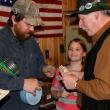 Treasurer Keith Royal sells a raffle ticket to Earl Leavitt as Jackie Steinmetz eagerly waits her turn. The monthly $1 raffle drew a long line. SUE MELLO/Boothbay Register