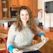 Abby Gordon at her Boothbay Harbor condo, catching up on local news in the Boothbay Register. LISA KRISTOFF/Boothbay Register