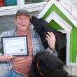 Owner Don Kingsbury holds Two Salty Dog’s award, as Max the lab decides this “photo opportunity” would be better served as a puppy-kiss opportunity. Coal the lab relaxes in front.  KATRINA CLARK/Boothbay Register