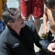 A hermit crab rests on Brian Boone's hand while onlookers get a better look at the bounty the diver pulled from the water. Boone was able to pull out a variety of creatures from a short dive. BEN BULKELEY/Boothbay Register