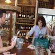 Inside Treat's on Main Street during the Wiscasset Art Walk July 25, Adam Wilson left, of SoPo Wine in South Portland serves up samples to Mary Kay and Joe Faccibene of New York City. SUSAN JOHNS/Wiscasset Newspaper
