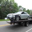 A Lincoln Towncar that collided with a dumptruck is towed away from the accident scene. RYAN LEIGHTON/Boothbay Register